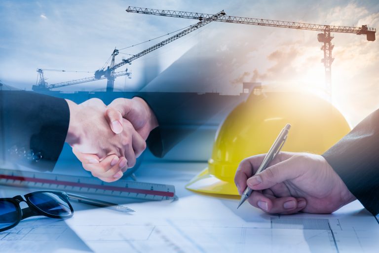 Double,Exposure,Of,Construction,Site,And,Business,People,Shaking,Hands