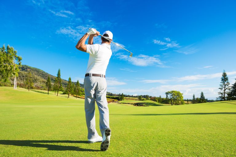 Golfer,Hitting,Golf,Shot,With,Club,On,The,Course
