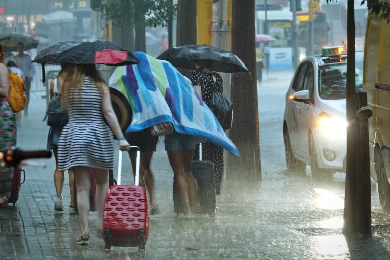 Barcelona,,Spain,-,August,2018;,Women,Walk,Under,Umbrella,During