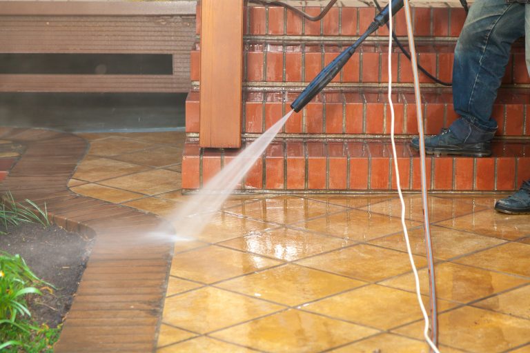 Modern,Cleaning.,A,Worker,Washes,The,Brick,Steps,Of,The