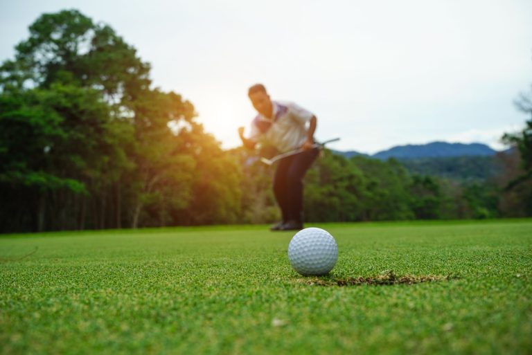 Blurred,Golfer,Playing,Golf,In,The,Evening,Golf,Course,,On