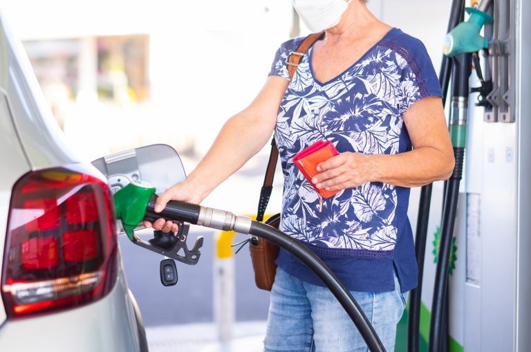 Woman,Holding,Petrol,Gasoline,Fuel,Pump,To,Refuel,Her,Silver