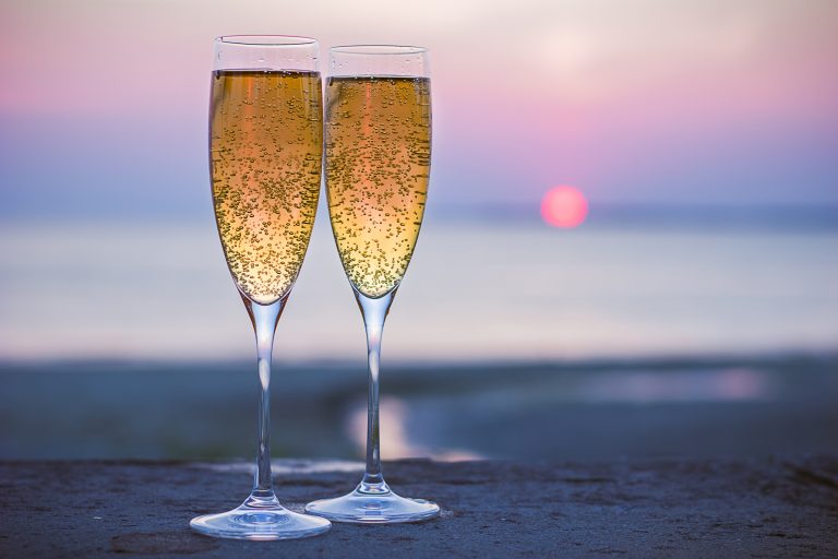 Two,Glasses,Of,Sparkling,Wine,At,Sunset,On,The,Sea
