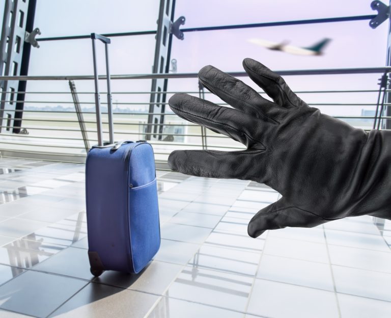 Closeup,Of,A,Hand,Of,A,Thief,Stealing,A,Suitcase
