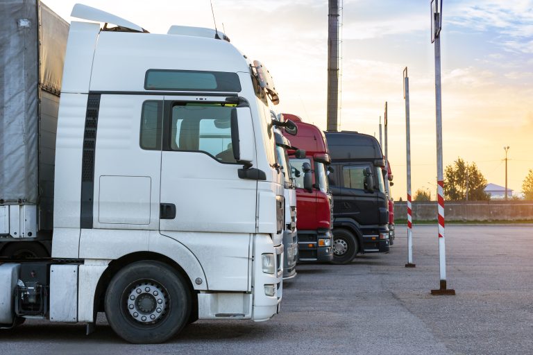 Heavy,Trucks,Loaded,With,Goods,Trailers,,Parked,In,Waiting,Area