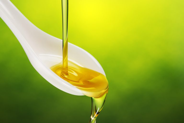 Extra,Virgin,Olive,Oil,Poured,In,A,Spoon,Overflowing,On
