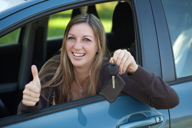 A,Smiling,Woman,Is,Leaning,Out,Of,The,Window,And