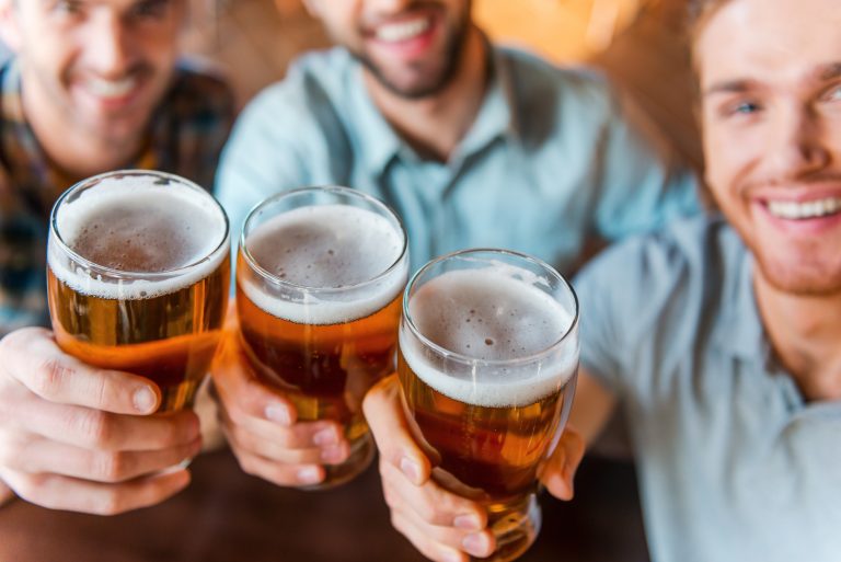 Cheers,To,Success!,Top,View,Of,Three,Happy,Young,Men