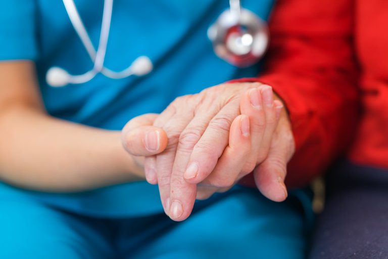 Young,Doctor,Giving,Helping,Hands,For,Elderly,Woman