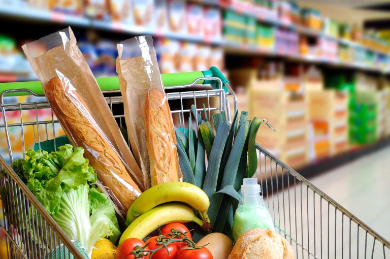 Shopping,Cart,Full,Of,Food,In,The,Supermarket,Aisle.,High