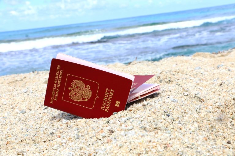 Russian,Passports,On,The,Beach,On,The,Sea,Background.,Travel