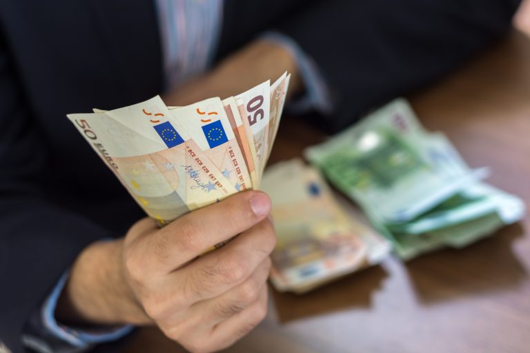 Hand,In,Suit,Holding,Fifty,And,Hundred,Euro,Bill,Notes