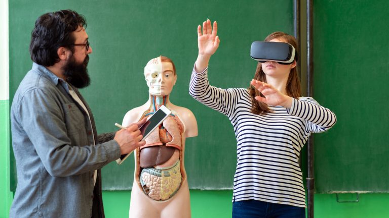 Young,Teacher,Using,Virtual,Reality,Glasses,And,3d,Presentation,To