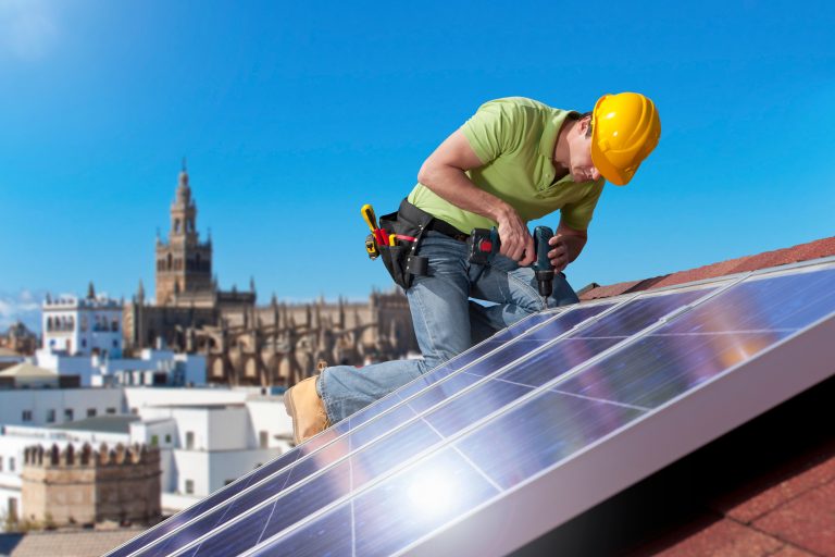 Engineer,Fitting,Solar,Panels,To,Roof,Of,House