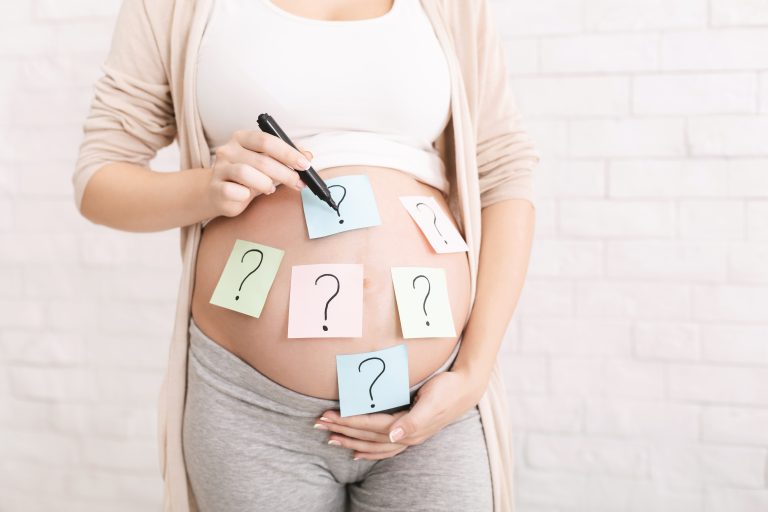 Choosing,Baby,Name.,Pregnant,Woman,Embracing,Her,Belly,With,Question