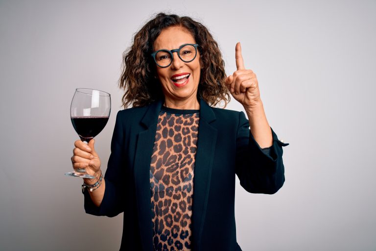 Middle,Age,Brunette,Woman,Drinking,Glass,Of,Red,Wine,Over