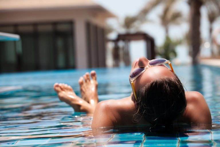 Portrait,Of,Sexy,Cheerful,Woman,Relaxing,At,The,Luxury,Poolside.