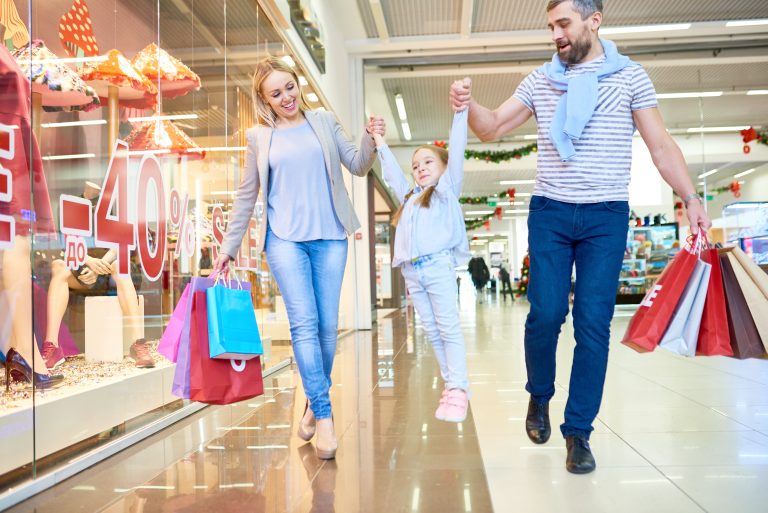 Full,Length,Portrait,Of,Carefree,Family,Shopping,In,Mall,Walking