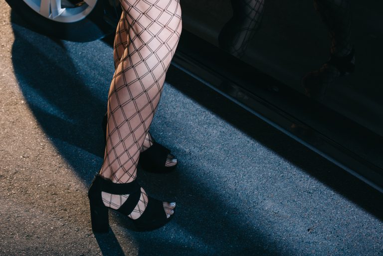 Cropped,View,Of,Woman,In,Mesh,Stockings,Standing,In,Shoes