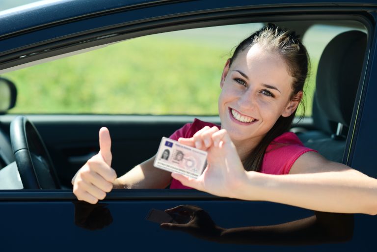 Cheerful,And,Happy,Young,Woman,In,Her,Car,Showing,Her