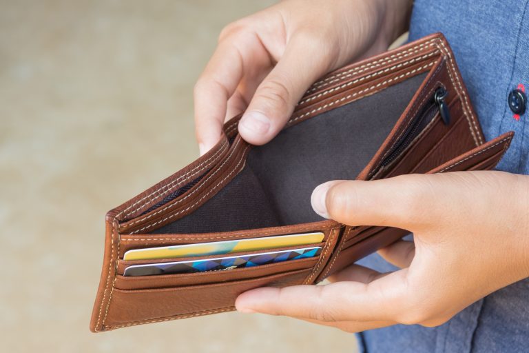 Business,Person,Holding,An,Empty,Wallet,(no,Money)