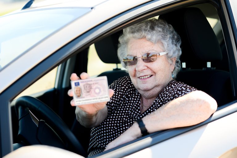 Happy,Cheerful,Elderly,Senior,Woman,Driving,Her,Car,And,Showing