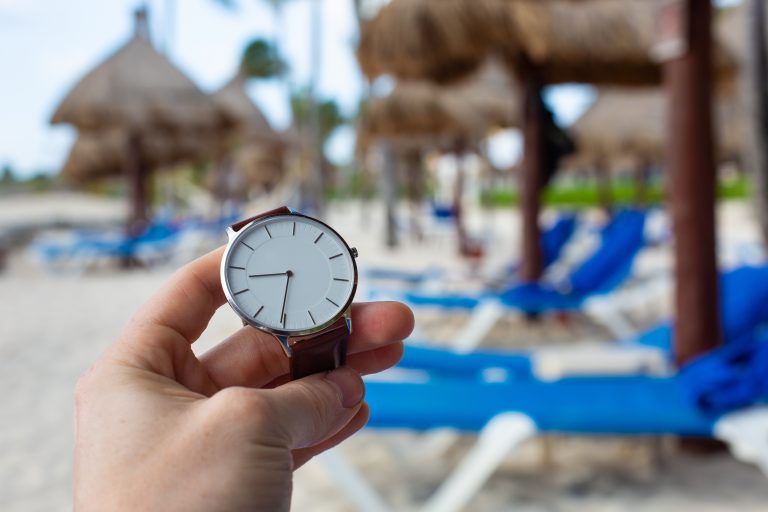A,Man,Holding,A,Watch,And,Checking,The,Time,While