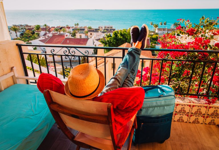 Young,Man,Relax,On,Balcony,Terrace,With,Suitcase,,Travel,Concept
