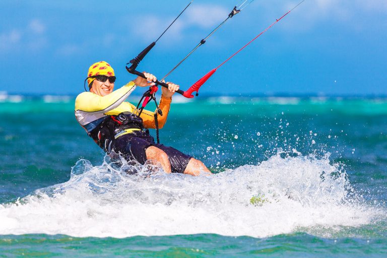 Young,Smiling,Kitesurfer,On,Sea,Background