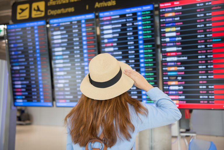 Tourist,Is,Checking,Time,Table,Of,Flight,At,The,Airport.