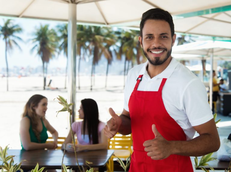 Laughing,Waiter,Of,A,Cocktail,Bar,At,Beach