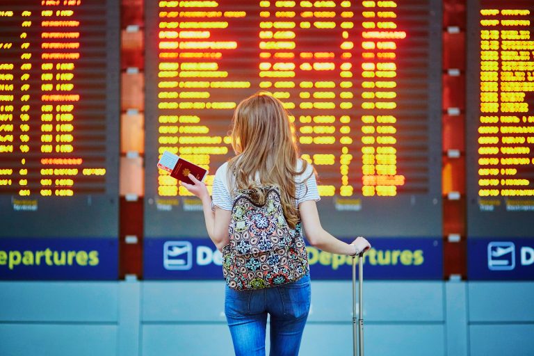 Beautiful,Young,Tourist,Girl,With,Backpack,And,Carry,On,Luggage