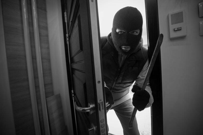 Burglar,Breaking,Door,Of,House,With,Crowbar