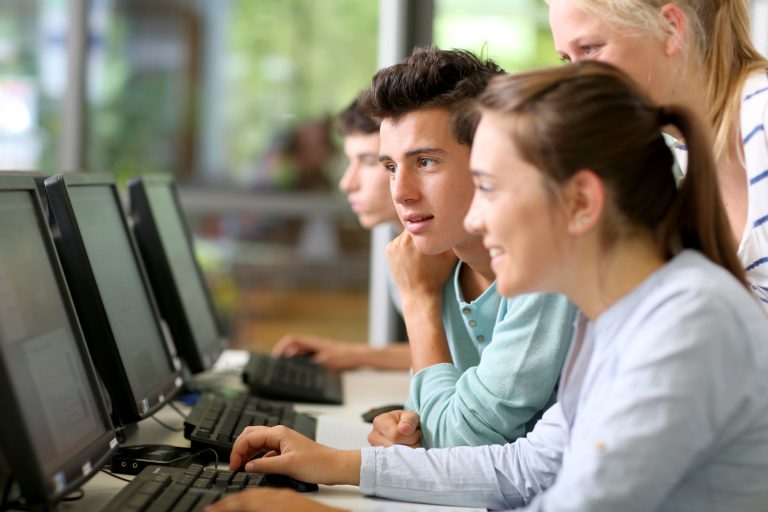 Students,In,Class,Working,On,Desktop,Computer