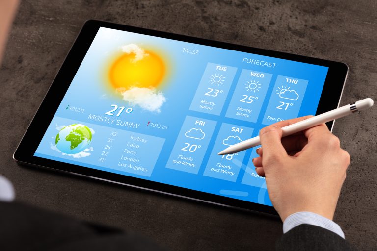 Business,Woman,Checking,Weekly,Weather,Forecast,On,Tablet