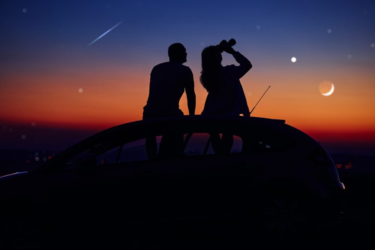 Couple,Stargazing,Together,With,A,Astronomical,Telescope.