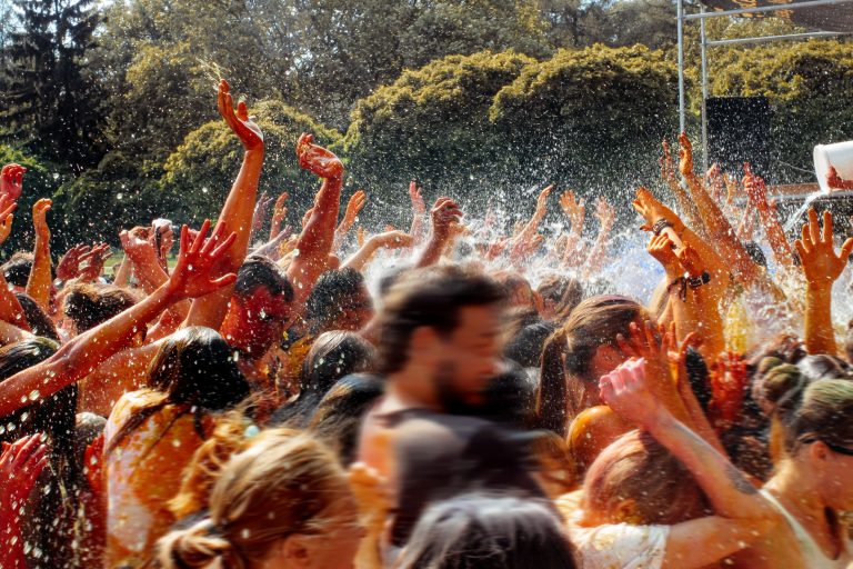 Hands,And,Happy,People,Crowd,Partying,Under,Rain,At,Holi