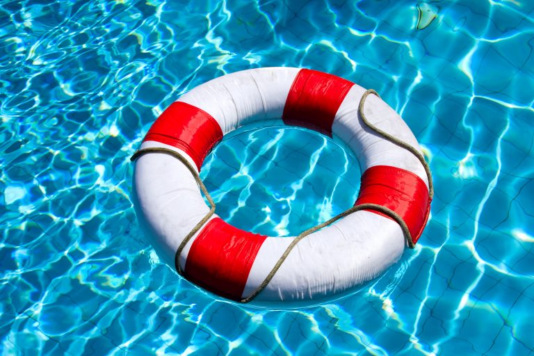 Life,Ring,Floating,On,Top,Of,Sunny,Blue,Water