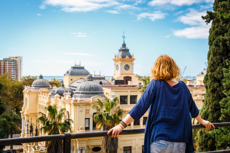 Woman,With,Blue,Shirt,Enjoys,The,View,Over,The,Town