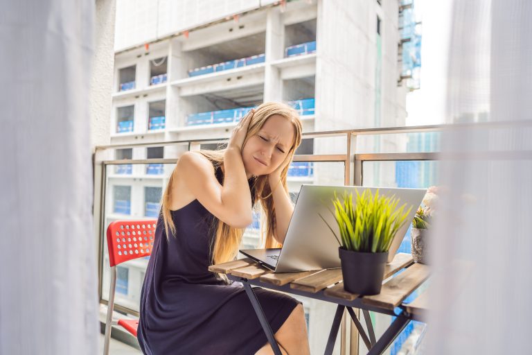 Young,Woman,Trying,To,Work,On,The,Balcony,Annoyed,By