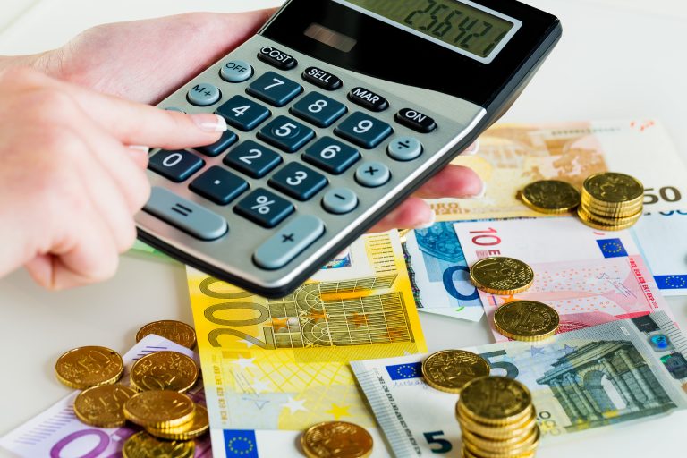 Hand,With,Calculator,And,Bills.,Symbolic,Photo,For,Turnover,,Profit,