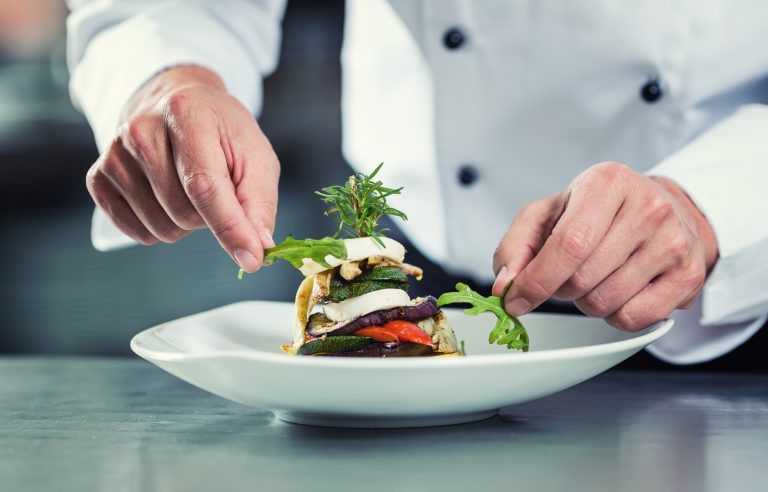 Chef,In,Restaurant,Garnishing,Vegetable,Dish,,Crop,On,Hands,,Filtered
