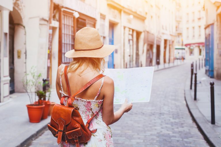 Woman,Tourist,Looking,At,The,Map,On,The,Street,Of