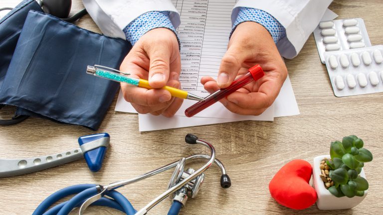 Doctor,During,Consultation,Held,In,His,Hand,And,Shows,Patient