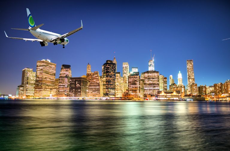 Airplane,Landing,In,New,York,At,Night.,Manhattan,Skyline,On