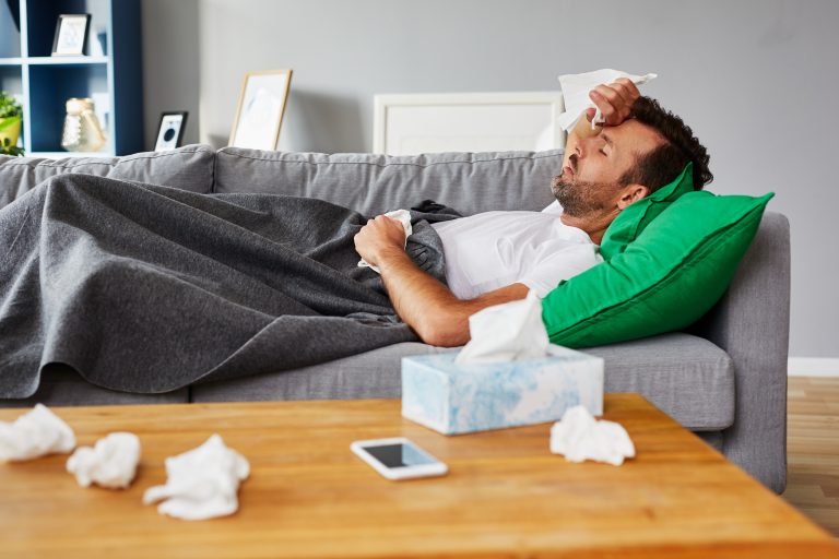 Sick,Man,With,Fever,Lying,On,Couch,At,Home