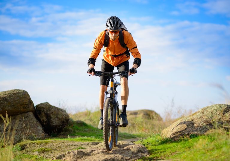 Cyclist,Riding,The,Bike,On,The,Beautiful,Spring,Mountain,Trail