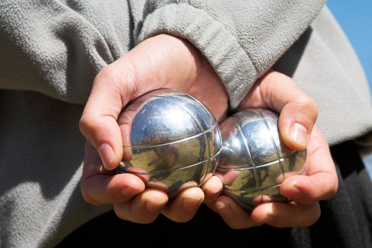 The,Hands,Of,A,Man,Holding,Petanque,(boule),Balls