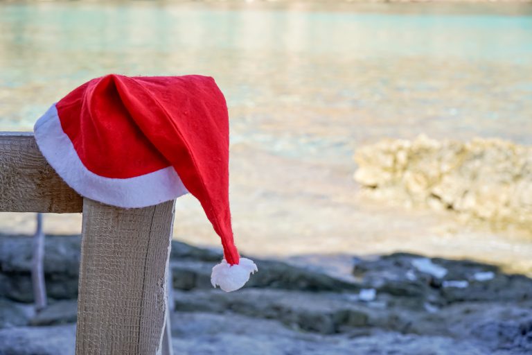 Santa,Claus,Hat,On,The,Beach,Of,A,Spanish,Island.