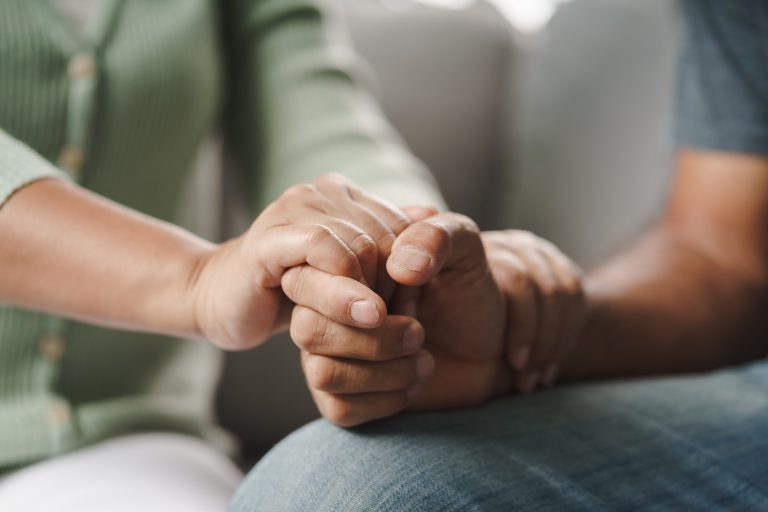 Female,Friend,Or,Family,Sitting,And,Hold,Hands,During,Cheer